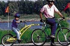 Kid riding a trail-a-bike